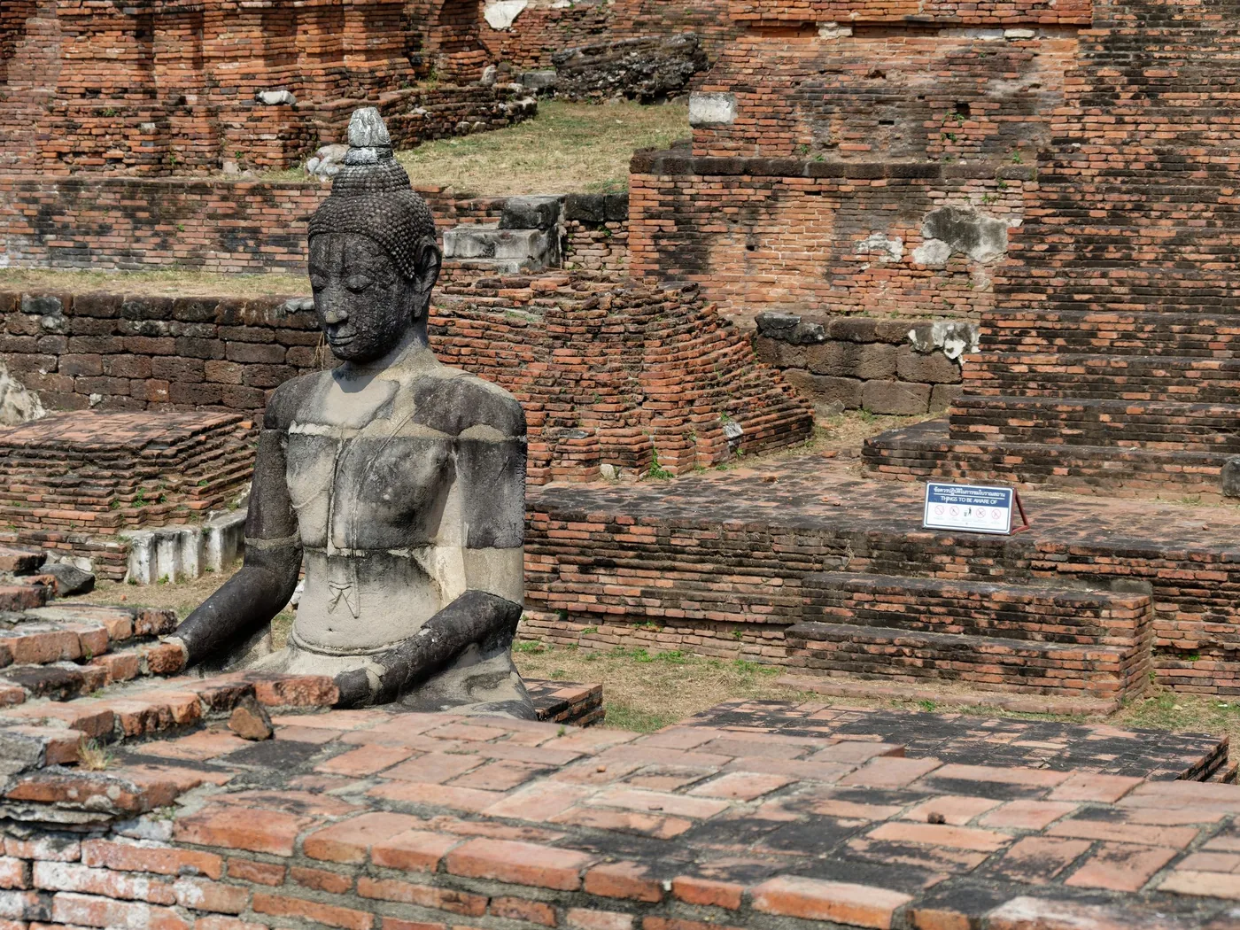A seated Buddha statue among the ruins of Ayutthaya